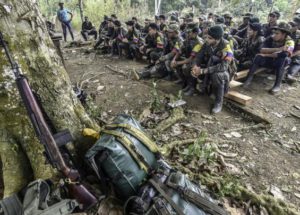Demobilized FARC fighters listen to a commander speak just before surrendering their weapons in a reintegration camp, in Colombia, on February 28, 2017.