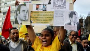 Protesters hold up signs commemorating human rights defenders and community leaders who have been murdered in Colombia, in this undated file photo. Colombia